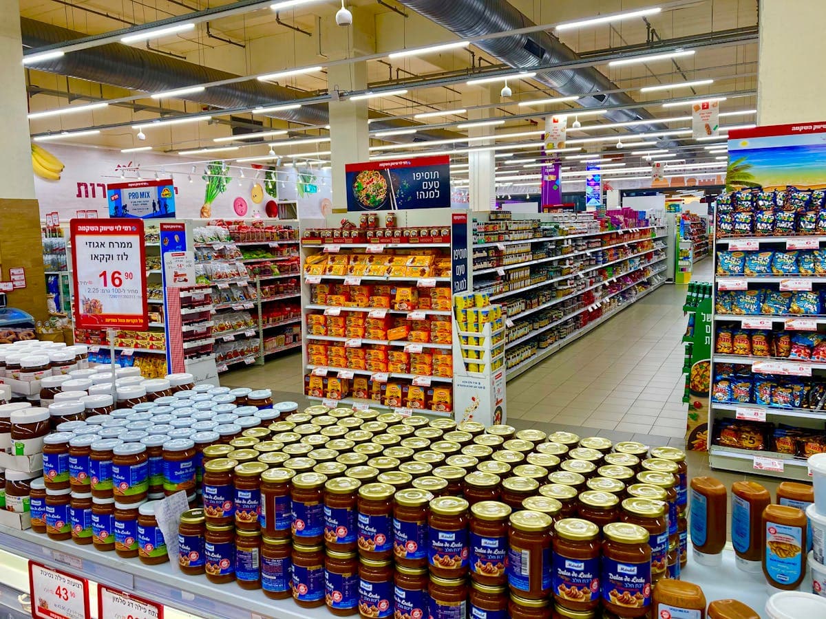 Grocery liquidation warehouse with pallets of brand-name food products and snack inventory