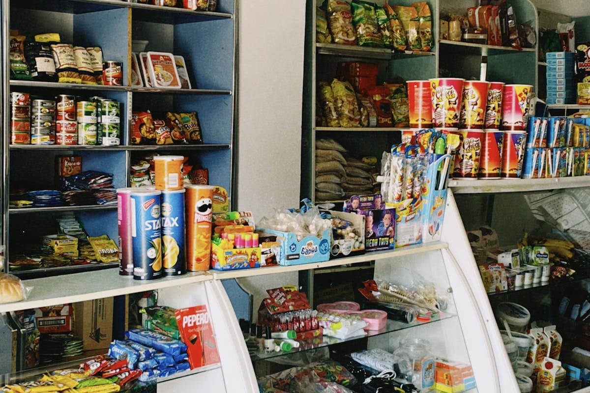 Grocery store shelves stocked with closeout food products organized by category with clear dating labels
