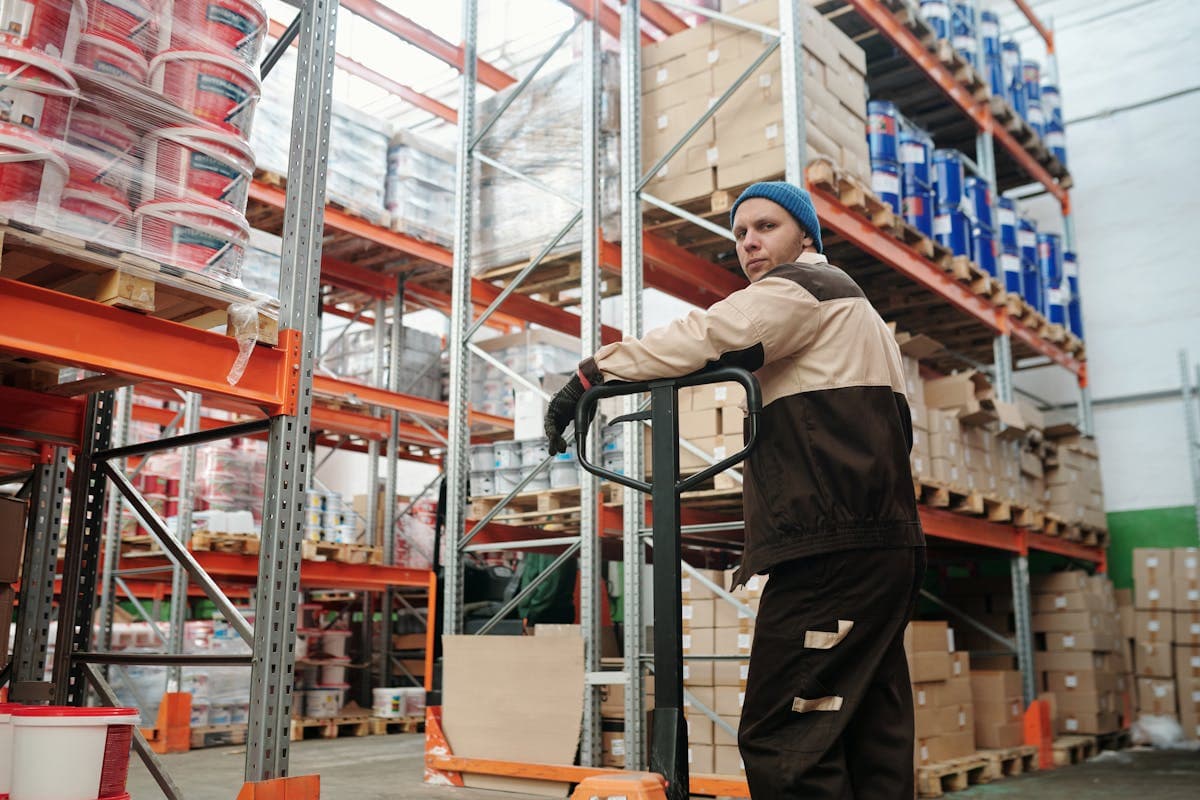 Customer returns pallets from major retailers being sorted and processed at a liquidation warehouse